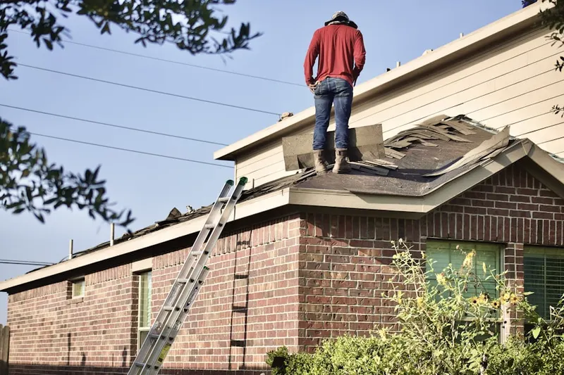 Professional roofer working on a residential roof in Cordova